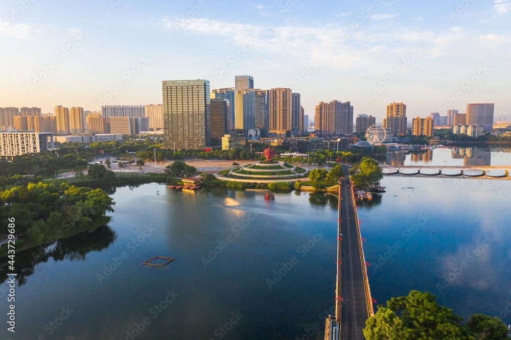 Fototapeta premium Skyline by Baijia lake at sunrise in Nanjing city in summer