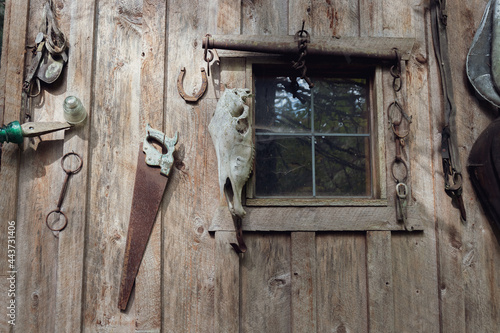 Close-up of Rustic Decorations Hanging on Side of Wood Shed