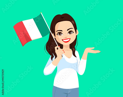 Beautiful brunette italian woman holding Italy flag on green background