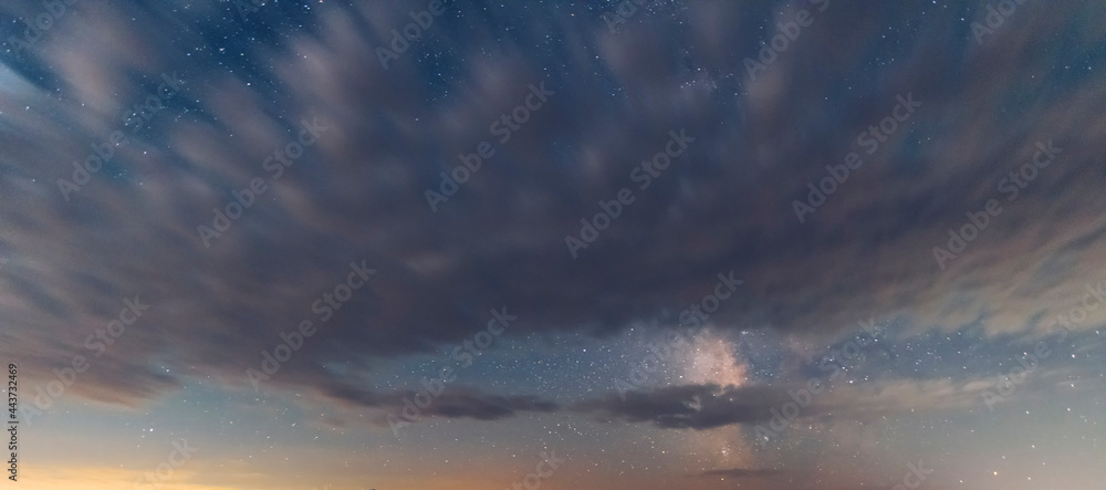 Beautiful starry sky with long exposure clouds. Night sky, astronomical background.