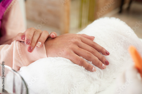 detail of manicured hands after treatment with a professional manicurist  self-care concept