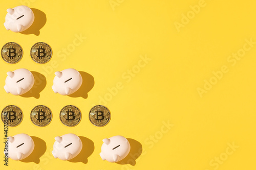 Little pink ceramic piggy bank pattern and bitcoin pattern on the left side on yellow background. Concept of cryptocurrency, saving money and savings.