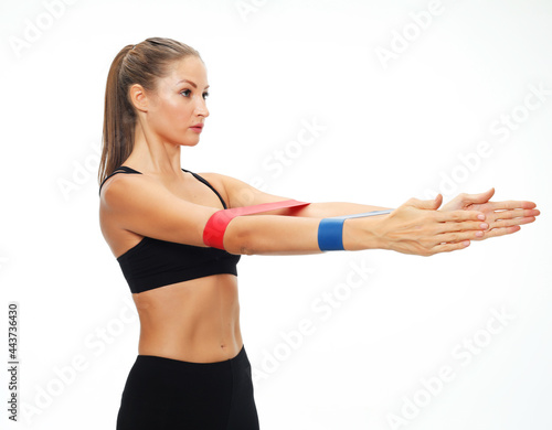 Sports woman performs exercises for the muscles of the hands.
