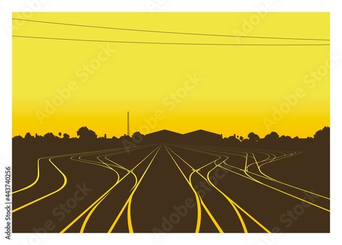 Rail yard at the afternoon with building and trees silhouette background