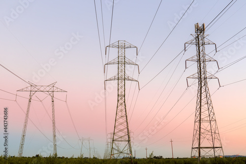 High Voltage Power Lines with Twilight Skies in Central California. Dixon, Solano County, California, USA.