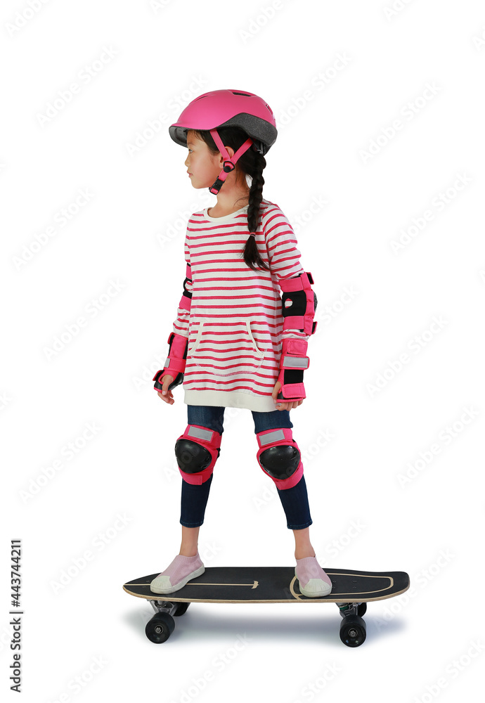 Asian little girl child skating on skateboard isolated over white background. Kid riding on skateboard. Image with Clipping path Asian little girl child skating on skateboard isolated over white background. Kid riding on skateboard. Image with Clipping path