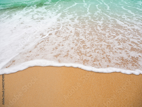 White foam wave blue sea on sand beach background at coast close up. wonderful Phuket island ocean  nature landscape outdoor. flat lay with free space. tropical tourist summer holidays travel concept.