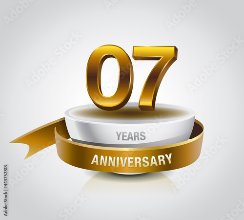 7 years golden anniversary logo celebration with ring and ribbon.