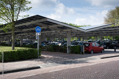 Solar energy panels installed on the canopy of a car parking area in the center of the Dutch city Dronten. Sustainable energy and shade at the same time