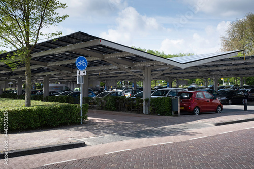 Solar energy panels installed on the canopy of a car parking area in the center of the Dutch city Dronten. Sustainable energy and shade at the same time photo