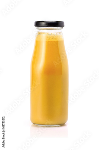 Yellow orange smoothie juice in glass bottle isolated on white background.