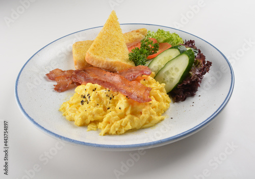 western big breakfast with butter toast, fried scramble egg, sausage, grill bacon, ham, omelette, bean and salad halal breakfast menu 