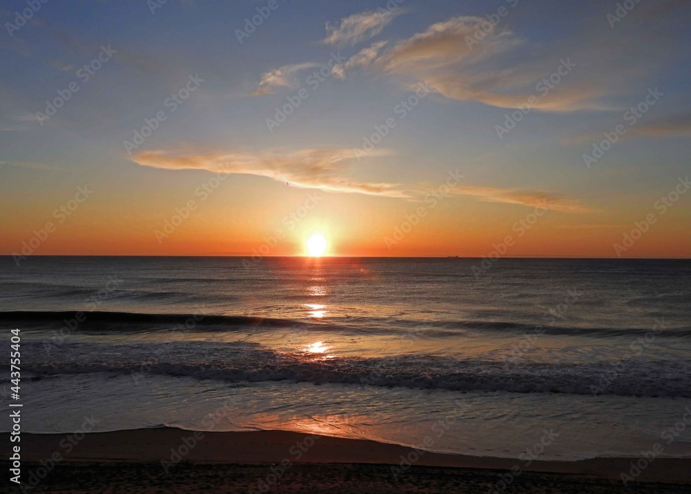 tranquil sunrise over the beach at rehoboth beach, delaware, as  seen from henlopen hotel