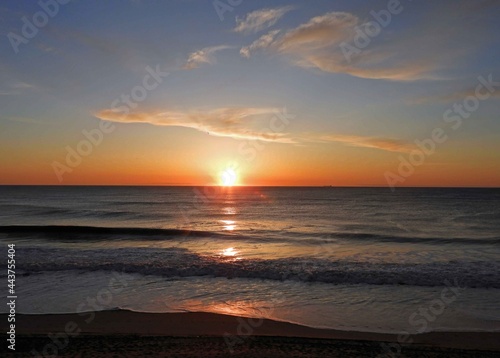 tranquil sunrise over the beach at rehoboth beach  delaware  as  seen from henlopen hotel