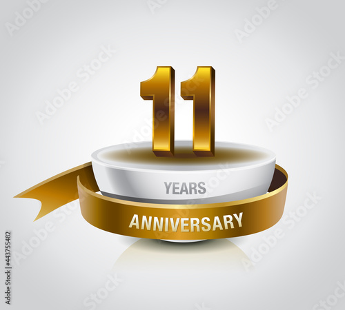 11 years golden anniversary logo celebration with ring and ribbon.
