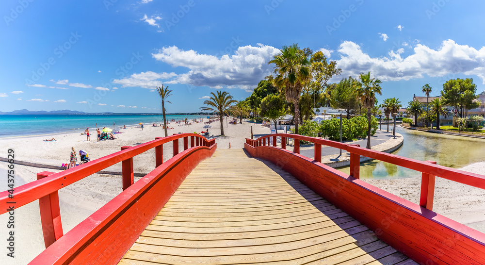 Landscape with red boardwalk at the coastline of Platja de Muro in Alcudia bay, Majorca Island, Spain