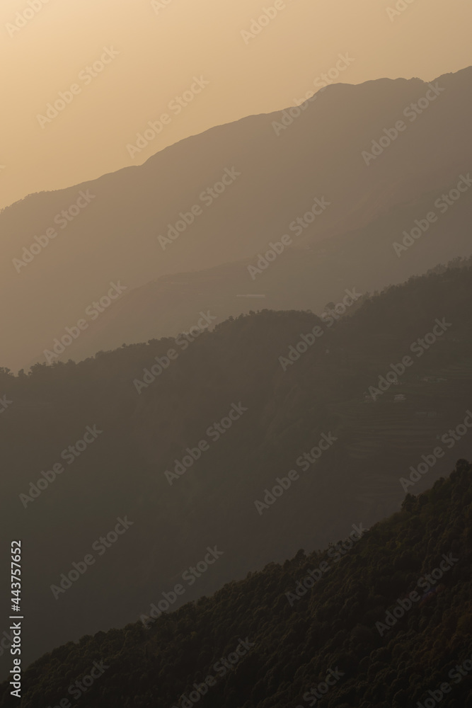 layers of mountain on a smoggy day during golden hour