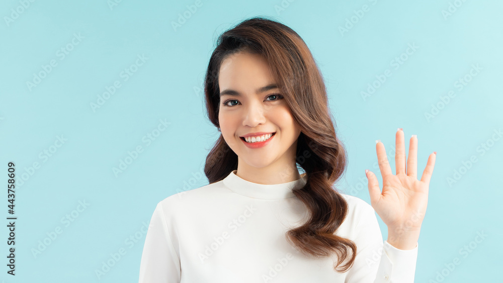 Hi what is up. Portrait of carefree friendly asian female entrepreneur, smiling broadly while waving raised palm Hi what is up. Portrait of carefree friendly asian female entrepreneur, smiling broadly while waving raised palm