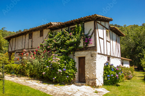 Old and traditional Spanish house among green vegetation.