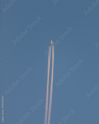Plane flying overhead with blue sky