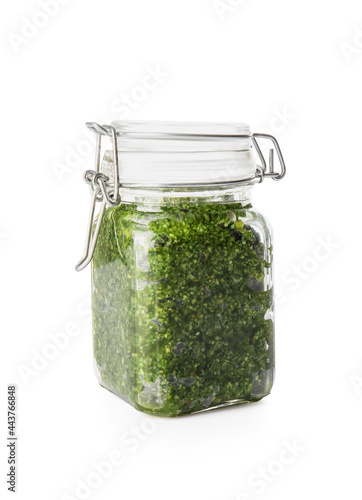 Jar with fresh pesto sauce on white background