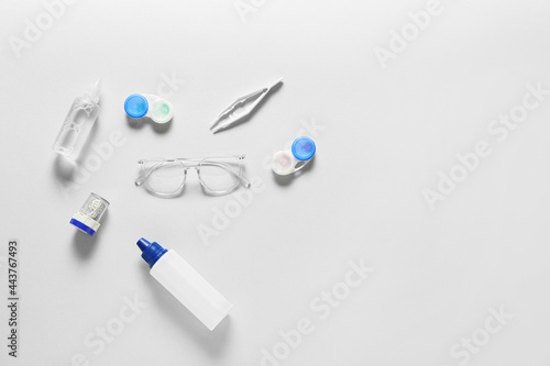 Composition with eyeglasses and contact lenses on light background