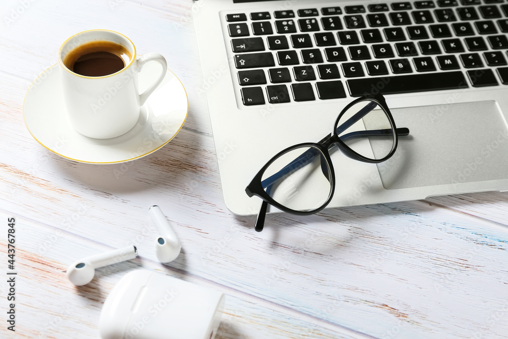 Composition with eyeglasses and cup of coffee on light wooden background Composition with eyeglasses and cup of coffee on light wooden background