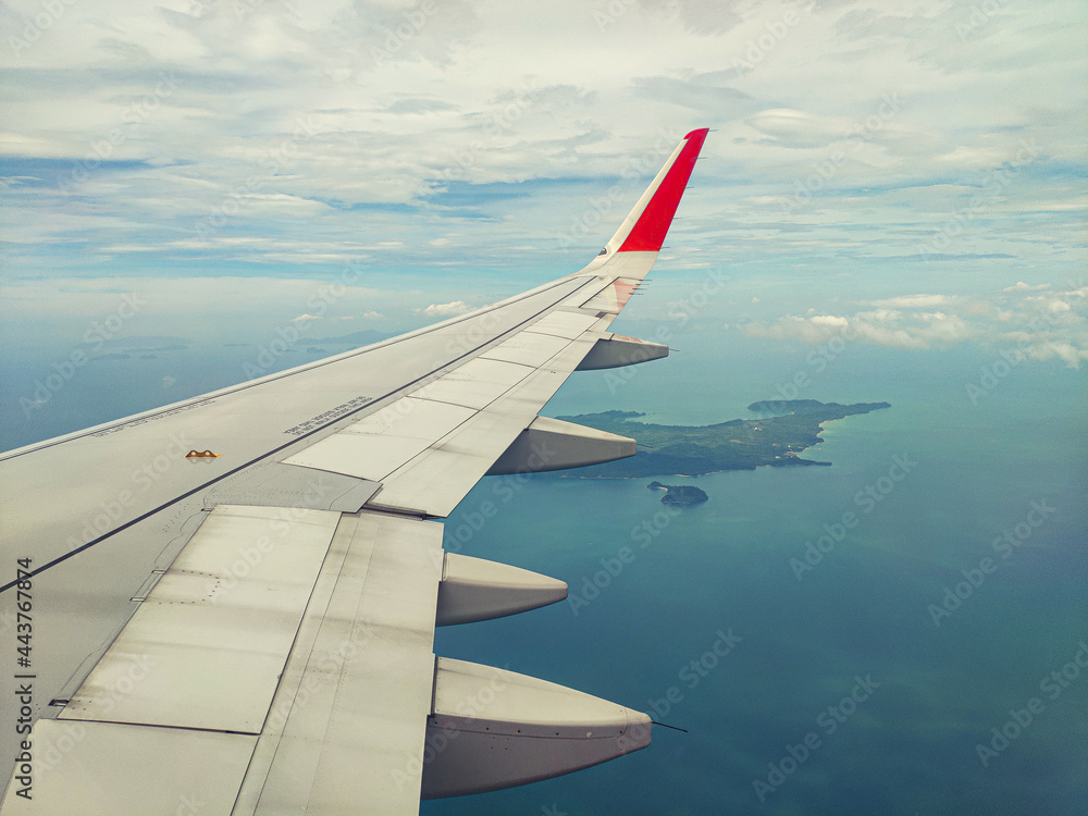 Aircraft wing through window with ocean background. Aircraft wing through window with ocean background.
