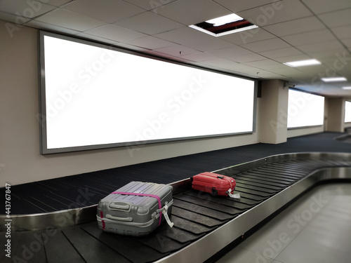 Blank poster banner over luggage belt display.White billboard for promotion announcement and business advertising information mock up.