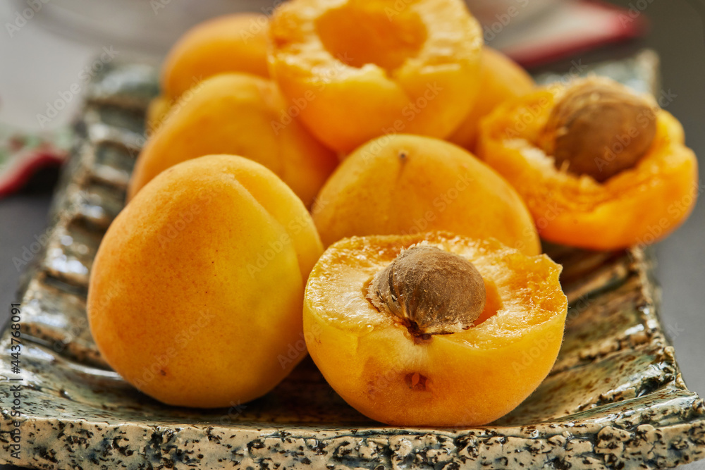 Fresh apricots whole and cut in half with seeds, ready to eat