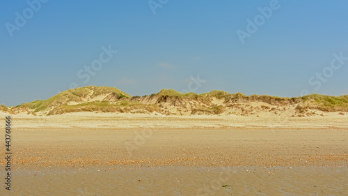 Sand beach and dunes on the North sea Opal coast under a clear blue sky, Nord PAs De calais, France 