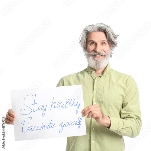 Senior man holding poster w...