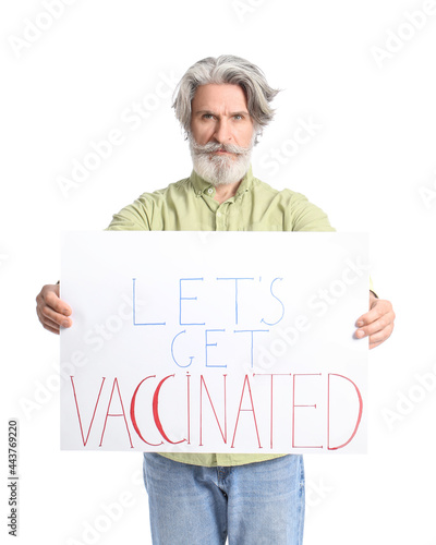 Senior man holding poster w...