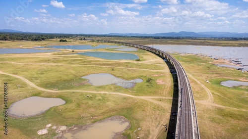 Aerial Unseen view of railroad tracks of floating Train bridge with white car in Khok Salung, Pa Sak Jolasid dam Lopburi amazing Thailand, Known as a floating train route. photo