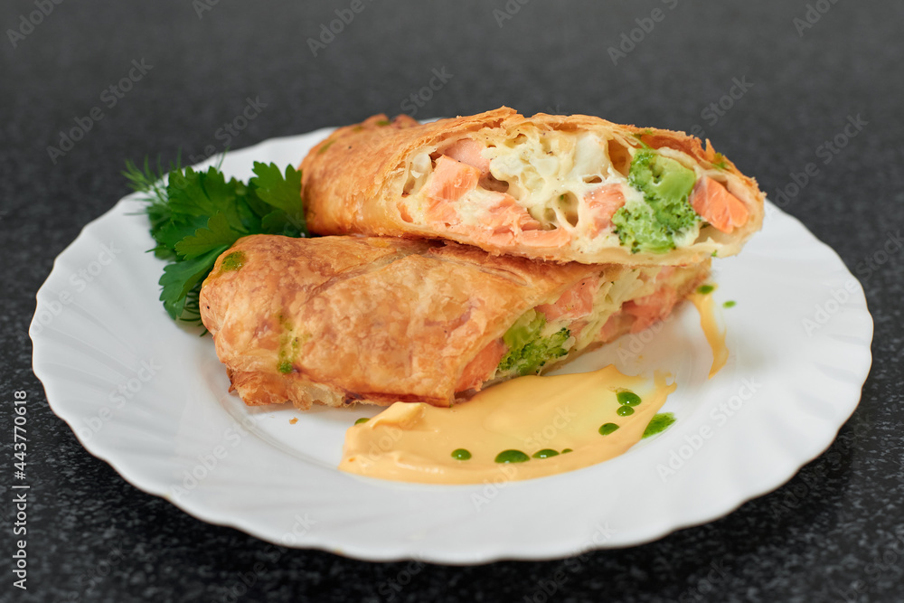 Puff pastry roll stuffed with salmon and broccoli