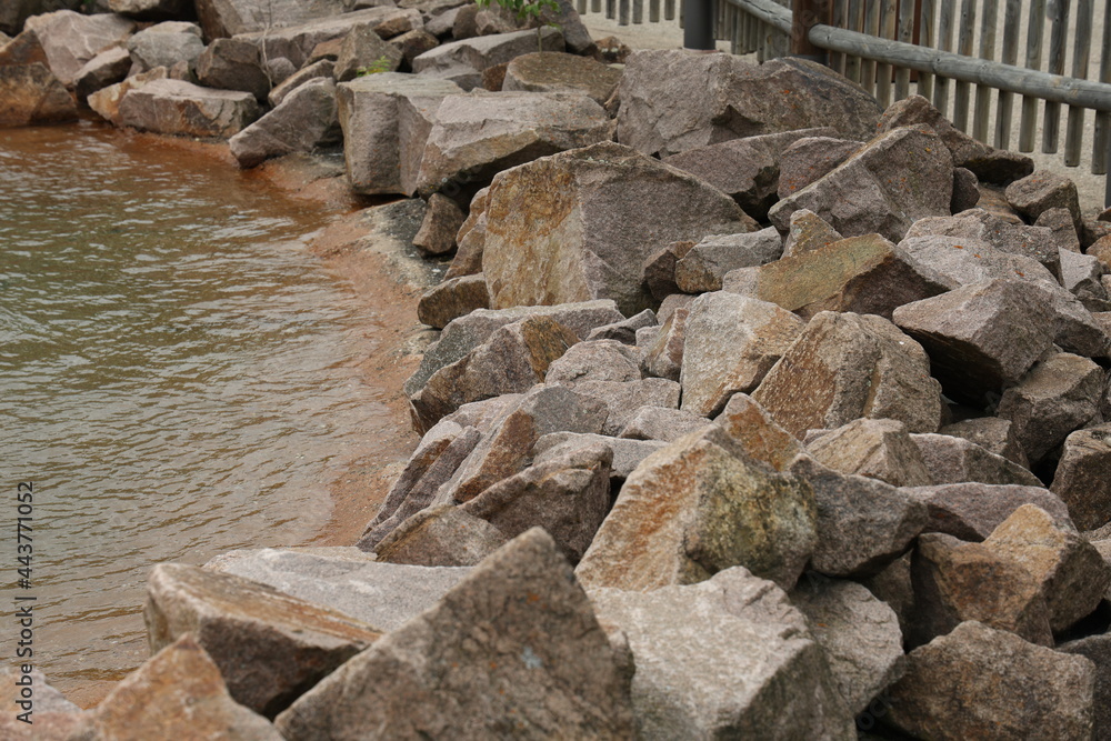 Piles of natural stones by the lake Piles of natural stones by the lake