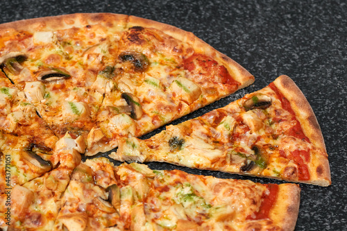 Sliced pizza with chicken, mushrooms and cheese