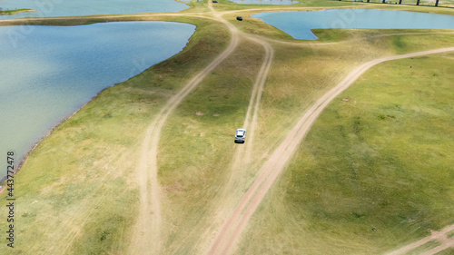 Aerial Unseen view of railroad tracks of floating Train bridge with white car in Khok Salung, Pa Sak Jolasid dam Lopburi amazing Thailand, Known as a floating train route. photo