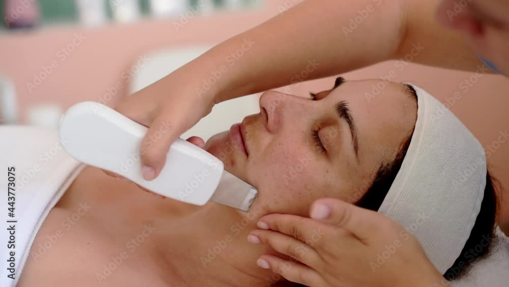 Cleaning and moisturise nourish skin of face. ultrasound skin cleansing procedure of face. Woman receiving facial lifting and moisturising peeling. Treatment skin care in cosmetology spa salon. Cleaning and moisturise nourish skin of face. ultrasound skin cleansing procedure of face. Woman receiving facial lifting and moisturising peeling. Treatment skin care in cosmetology spa salon.