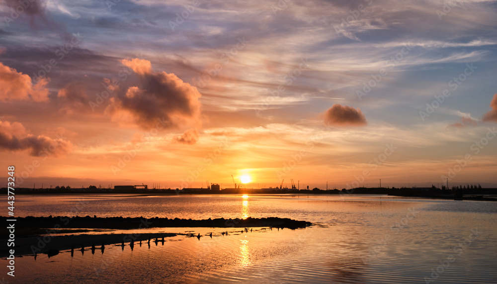 Sunset over the sea at salt flats in Aveiro, Portugal.