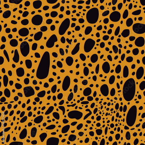Black spots on an orange background in the shape of a leopard. Seamless, vector.