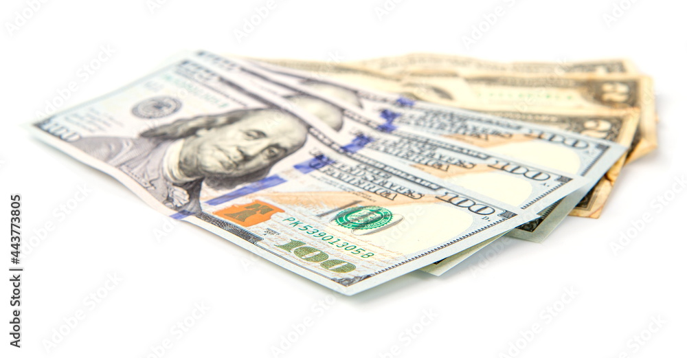 several large and small dollar bills fanned out isolated on white background several large and small dollar bills fanned out isolated on white background