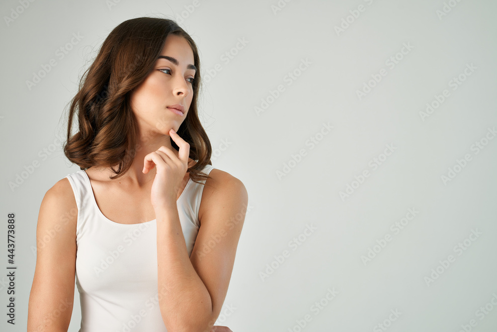 pretty brunette in white tank top holding her hair fashion glamor lifestyle pretty brunette in white tank top holding her hair fashion glamor lifestyle
