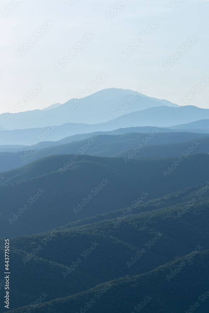 View of the mountain hills in the morning haze of fog