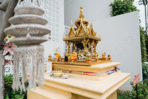 The small spirit house with flowers and other decorative stuff in Chiang Mai photo