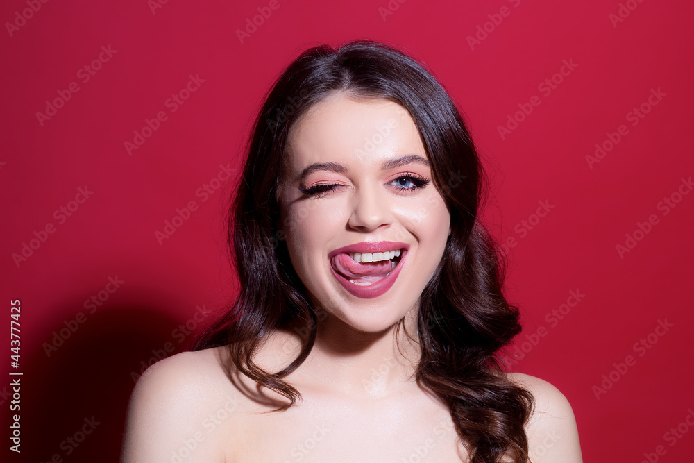 Beautiful sensual woman fashion model tongue licking lips. Sexy female posing in studio. Beautiful sensual woman fashion model tongue licking lips. Sexy female posing in studio.