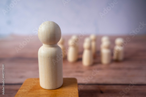 Wooden figures standing out from crowd.Depicts the ability of individual to influence and lead followers of other members.Success or talent and think different business creative concept.Unique Person