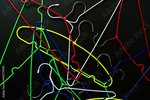 Lots of clothes hangers on a black background. View from above.
