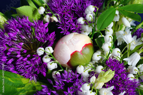 White and purple spring floral arrangement with alliums, lily of the valley and peony flowers