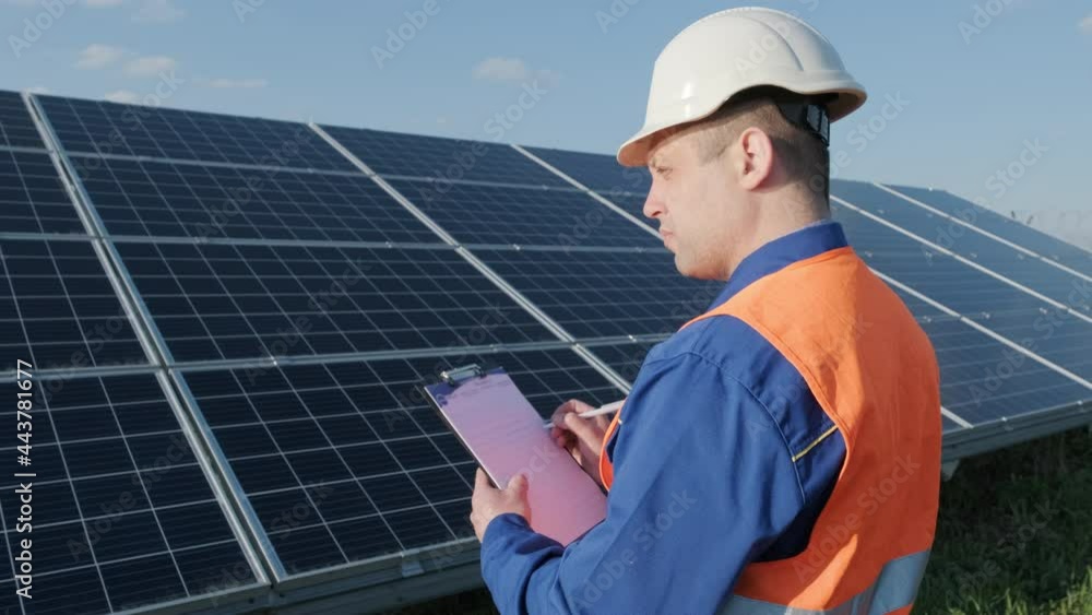 Inspector examination of photovoltaic modules, solar panels Inspector examination of photovoltaic modules, solar panels
